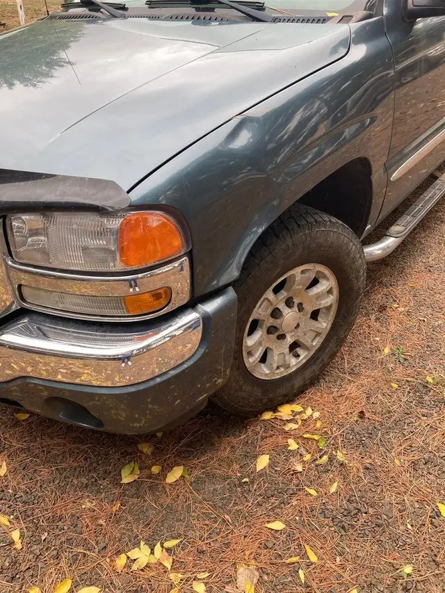 Slate GMC Sierra front quarter, finished, parked on autumn pine needles