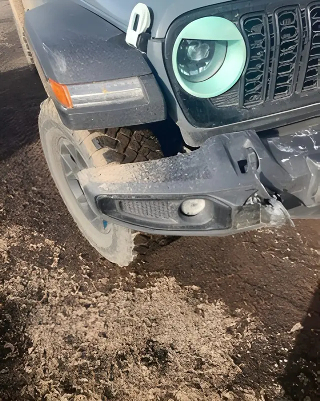 Jeep Wrangler with front-end collision damage before repair