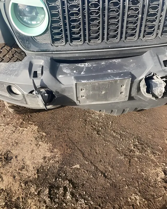 Jeep Wrangler front end damaged in a collision, before repair
